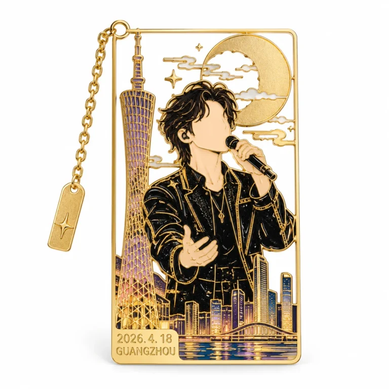 Gold-tone rectangular metal bookmark with a dark-haired singer, skyline, crescent moon and attached chain charm.