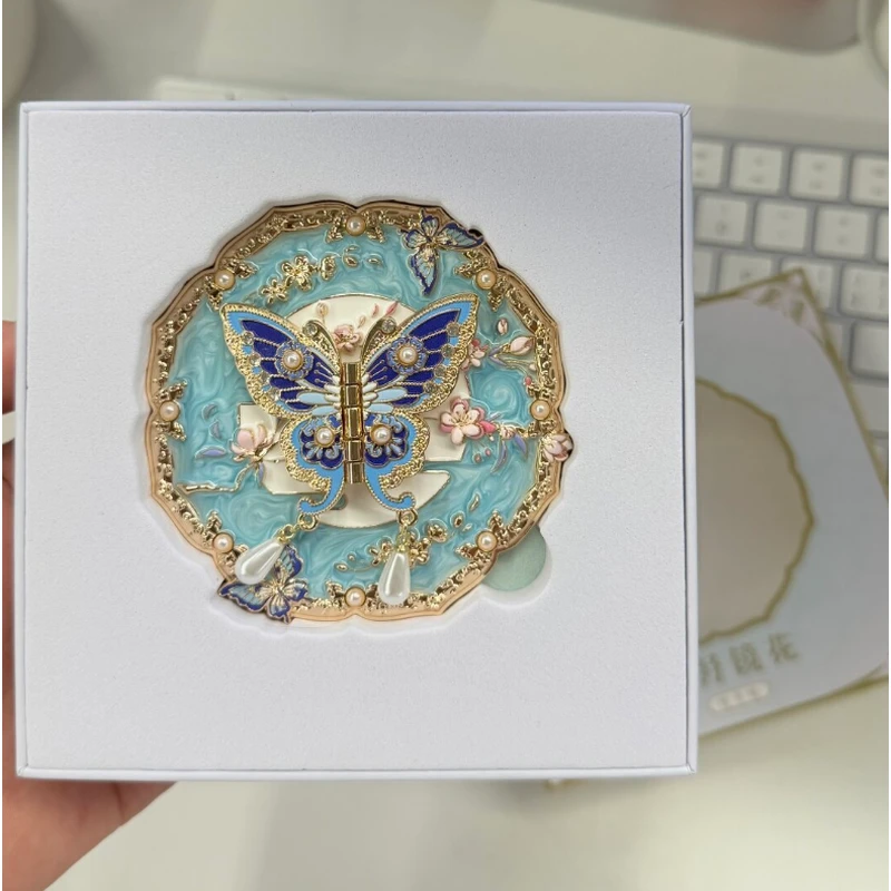Turquoise and gold-tone butterfly enamel compact mirror in a white gift box.