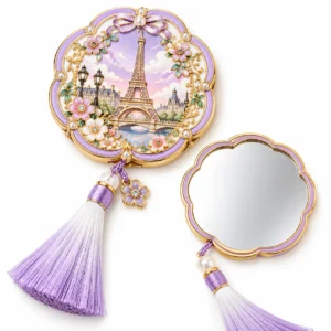 Pink and gold-tone tower enamel handheld mirror with pearl details and a purple tassel.