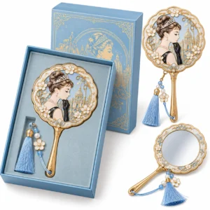Blue and gold-tone portrait handheld mirror with tassel, shown with its presentation gift box.