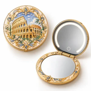 Gold-tone folding compact mirror with sculpted Roman architecture relief, shown open and closed.